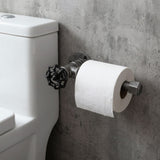 Wandtoiletrolhouder van zwart gietijzer met handwiel, naast het toilet gemonteerd