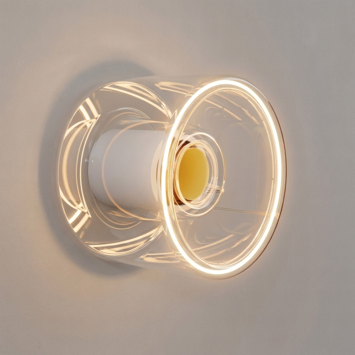E27 led-donutlamp van helder glas, Ø 120 mm, brandend als wandlamp in een minimalistisch interieur